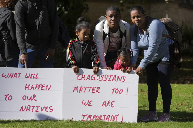 Chagossians Marie Michele, right, attends a protest to respond to the U.K. announcement agreeing to hand sovereignty of the long-contested Chagos Islands to Mauritius and against their "Exclusion" from Chagos negotiations, outside the House of Parliament, in London, Monday, Oct. 7, 2024. (AP Photo/Kin Cheung)