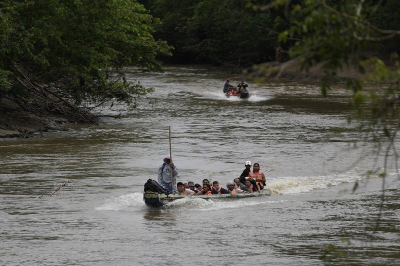 A boat takes migrants to Lajas Blanca, Panama, Thursday, Sept. 26, 2024, after their trek across the Darien Gap from Colombia in hopes of reaching the U.S. (AP Photo/Matias Delacroix)