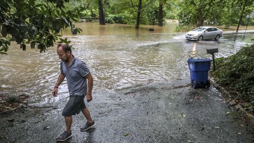 September 17, 2020 Atlanta: Peter Von Wismar walks back up his driveway after putting the recyclables out curbside where Peachtree Battle had to be closed at Woodward Way after Peachtree Creek rose from its banks in Atlanta. Remnants of Hurricane Sally, that downgraded to a tropical depression, moved through North Georgia on Thursday, Sept. 17, 2020. Heavy rain and flooding brought trees down and made a mess of the Thursday morning commute and knocked out power to thousands. By mid-day, Fulton, DeKalb and Gwinnett counties received between 2 and 4 inches of rain, and the Southside, between 1 and 3 inches. Areas like this would be identified in Fulton's updated Hazard Mitigation Plan. (John Spink / John.Spink@ajc.com)