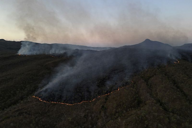 Fires spread through the environmental protection area of Pouso Alto, in Chapada dos Veadeiros National Park, during dry season, in Minas Sul, Goias state, Brazil, Monday, Sept. 9, 2024. (AP Photo/Eraldo Peres)