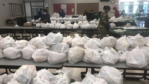 Atlanta Public Schools, with assistance from the Georgia National Guard, prepares to distribute meals to students and families on Monday, April 13, 2020. On the day after spring break, the district switched from a daily food distribution schedule to a weekly schedule to assist those affected by the coronavirus shutdown. SUBMITTED PHOTO FROM ATLANTA PUBLIC SCHOOLS SUPERINTENDENT MERIA CARSTARPHEN