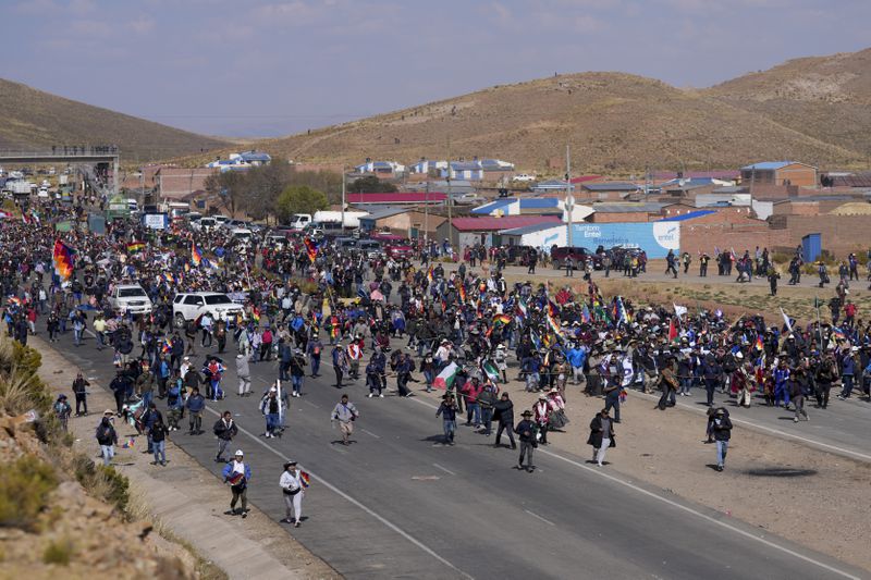 Supporters of former President Evo Morales, who are marching to the capital to protest the government of current President Luis Arce, walk toward Arce supporters who met them along the route in Vila Vila, Bolivia, Tuesday, Sept. 17, 2024. (AP Photo/Juan Karita)