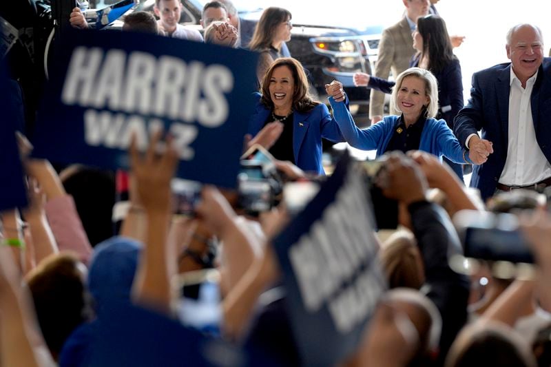 Democratic presidential nominee Vice President Kamala Harris, left, Democratic vice presidential nominee Minnesota Gov. Tim Walz, right, and his wife Gwen Walz arrive at Pittsburgh International Airport, Sunday, Aug. 18, 2024, in Pittsburgh, (AP Photo/Julia Nikhinson)