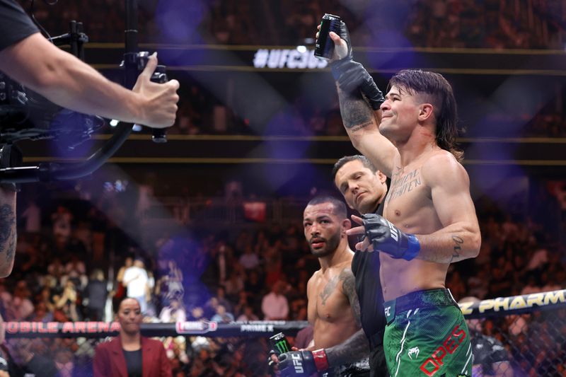 Diego Lopes, right, is declared the winner by unanimous decision over Dan Ige in a 165-pound catchweight mixed martial arts bout at UFC 303, Saturday, June 29, 2024, in Las Vegas. Ige replaced Brian Ortega, who withdrew from the bout due to illness. (Steve Marcus/Las Vegas Sun via AP)