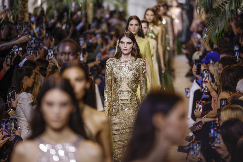 Models wear creations as part of the Elie Saab Spring/Summer 2025 collection presented Saturday, Sept. 28, 2024, in Paris. (Photo by Vianney Le Caer/Invision/AP)