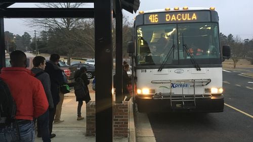 Riders board a GRTA Xpress bus in Dacula on the morning of Feb. 22. TYLER ESTEP / TYLER.ESTEP@AJC.COM