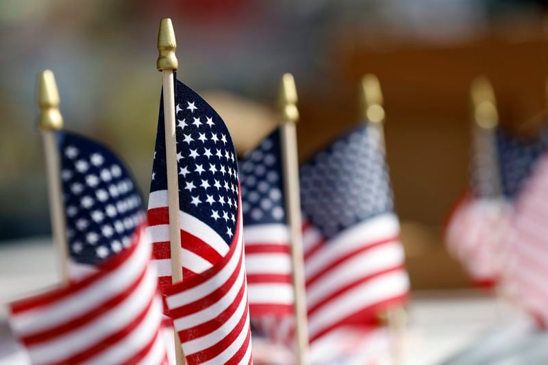 U.S. flags decorate tables during the Macon County Day Festival in Tuskegee, Ala., on Saturday, Aug 31, 2024. (AP Photo/ Butch Dill)