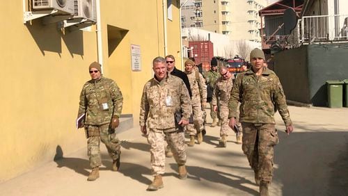 FILE - Marine Gen. Frank McKenzie, center, top U.S. commander for the Middle East, makes an unannounced visit in Kabul, Afghanistan, Jan. 31, 2020. (AP Photos/Lolita Baldor, File)