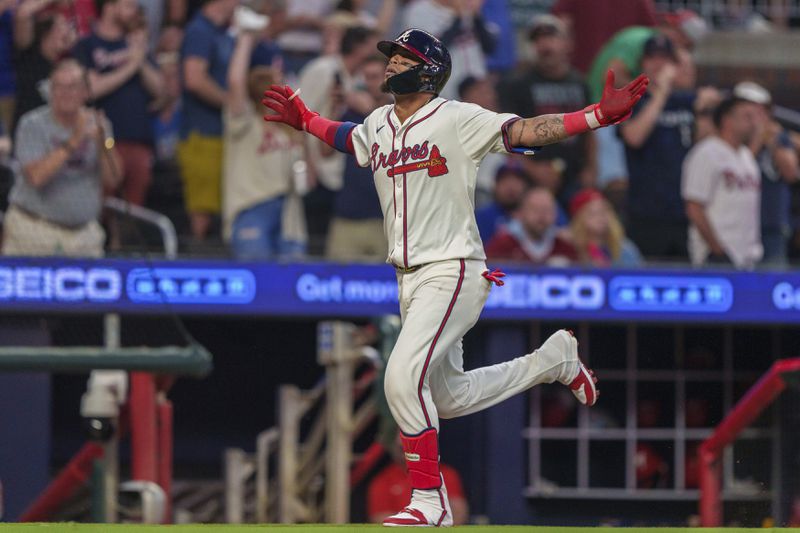 Atlanta Braves' Orlando Arcia waves to the crowd after hitting a two-run home run in the fourth inning of a baseball game against the Philadelphia Phillies, Wednesday, Aug. 21, 2024, in Atlanta. (AP Photo/Jason Allen)