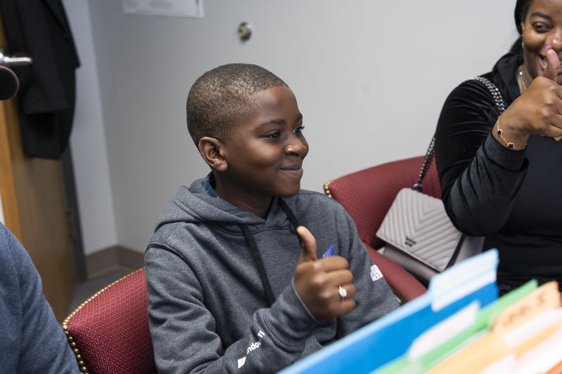 Nathan Mandeng, 11, from Cameroon, gives a thumbs-up to indicate that he is ready for his preliminary exam at Gwinnett County Public Schools' International Welcome Center in Lawrenceville on Monday, Oct. 9, 2023. (Olivia Bowdoin for The Atlanta Journal-Constitution)