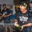 The Atlanta Braves celebrate in the locker room after clinching a wild-card playoff berth after the second baseball game of a doubleheader against the New York Mets, Monday, Sept. 30, 2024, in Atlanta. (AP Photo/Jason Allen)