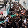 Mourners carry the bodies of 18 Palestinians who were killed in an Israeli airstrike during their funeral in Tulkarem, Friday, Oct. 4, 2024. (AP Photo/Nasser Nasser)