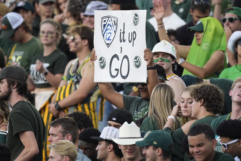 A Colorado State fan holds up a sign to mark the school's move to the Pac-12 Conference from the Mountain West during the first half of an NCAA college football game against Colorado, Saturday, Sept. 14, 2024, in Fort Collins, Colo. (AP Photo/David Zalubowski)