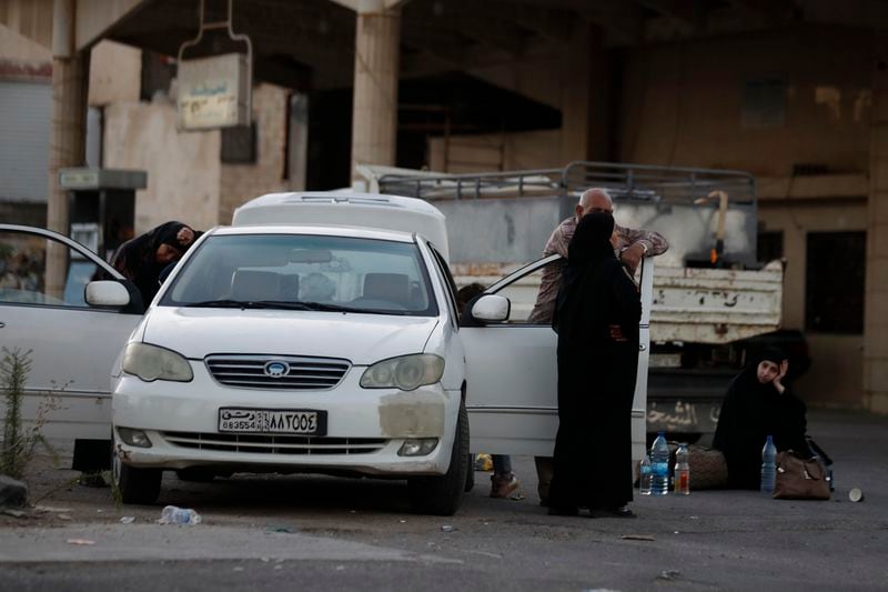 Lebanese fleeing the Israeli bombardment, arrive in a taxi at the Syrian-Lebanese border crossing in Jdaidet Yabous, Syria, Tuesday, Sept. 24, 2024. (AP Photo/Omar Sanadiki)