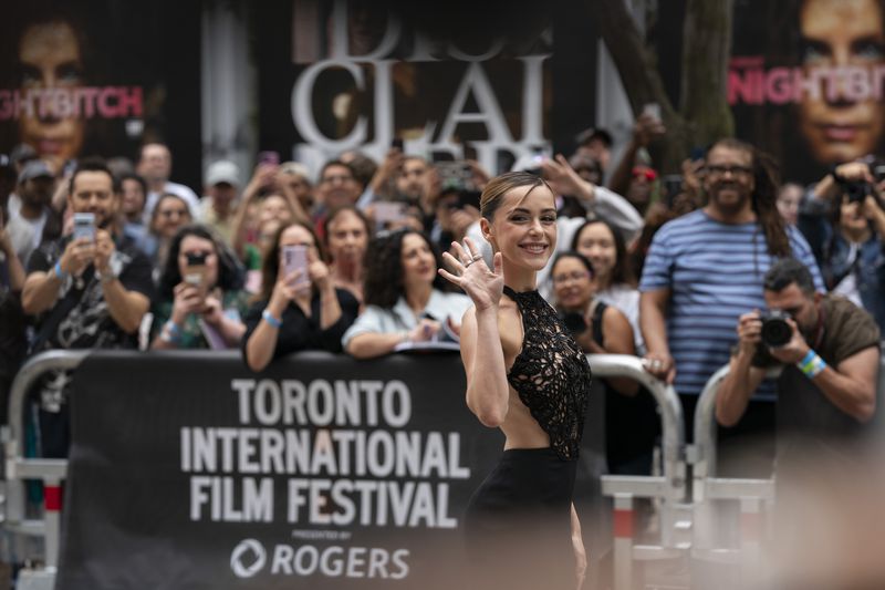 Kiernan Shipka poses for photos with fans at the premiere of "The Last Showgirl" at the Princess of Wales Theatre, during the Toronto International Film Festival, in Toronto, Friday Sept. 6, 2024. (Paige Taylor White/The Canadian Press via AP)