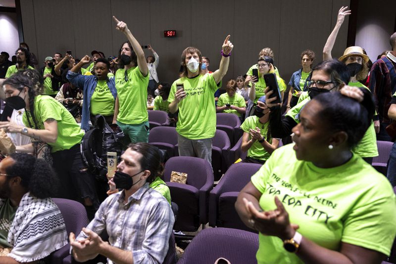 Opponents of the under-construction law enforcement training center known to some as Cop City disrupt the City Council meeting at City Hall in Atlanta on Monday, Sept. 16, 2024. (Arvin Temkar/Atlanta Journal-Constitution via AP)