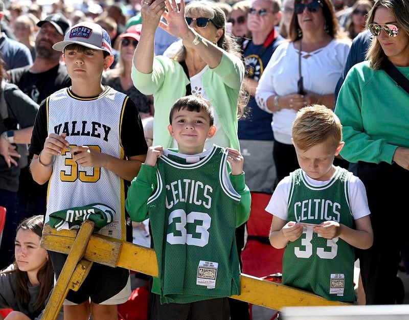 A youngster proudly displays his Larry Bird Boston Celtics jersey during the grand opening ceremony for the Larry Bird Museum, Thursday, May 30, 2024, in Terre Haute, Ind. (Joseph C. Garza/The Tribune-Star via AP)