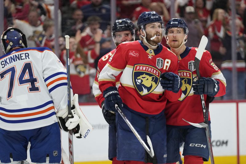 Florida Panthers left wing Matthew Tkachuk (19) reacts after scoring a goal against Edmonton Oilers goaltender Stuart Skinner (74) during the second period of Game 5 of the NHL hockey Stanley Cup Finals, Tuesday, June 18, 2024, in Sunrise, Fla. (AP Photo/Wilfredo Lee)