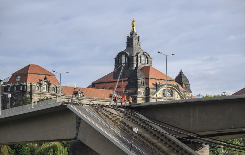 Parts of the Carola Bridge over the Elbe have collapsed in Dresden, Germany, Wednesday, Sept. 11, 2024. The State Chancellery can be seen behind it. (Robert Michael/dpa via AP)