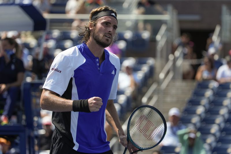 Stefanos Tsitsipas, of Greece, reacts after scoring a point against Thanasi Kokkinakis, of Australia,during the first round of the U.S. Open tennis championships, Tuesday, Aug. 27, 2024, in New York. (AP Photo/Pamela Smith)