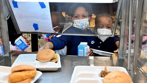 Kindergartner King Langford, 5, picks up his lunch at Cliftondale Elementary School in College Park on Wednesday, October 13. Metro Atlanta school districts are having to be creative to revise and rework menus because of national food supply issues. The COVID-19 pandemic has made it difficult for districts to get some of their usual food items. (Hyosub Shin / Hyosub.Shin@ajc.com)