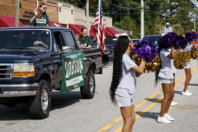 Alabama's new 2nd Congressional District Republican candidate Caroleene Dobson waves to the crowd as she rides in the parade during the Macon County Day Festival in Tuskegee, Ala., on Saturday, Aug 31, 2024. (AP Photo/ Butch Dill)