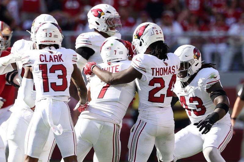 Arizona Cardinals linebacker Kyzir White, middle, is congratulated by teammates after intercepting a pass against the San Francisco 49ers during the second half of an NFL football game in Santa Clara, Calif., Sunday, Oct. 6, 2024. (AP Photo/Jed Jacobsohn)