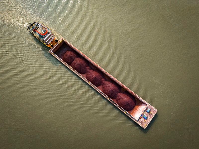 A tugboat pushes a barge with a light load across the Paraguay River in Mariano R. Alonso, Paraguay, Monday, Sept. 9, 2024. Water levels have plunged to their lowest-ever level amid a drought, according to Paraguay's Meteorology and Hydrology Office. (AP Photo/Jorge Saenz)