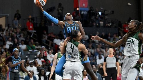 Atlanta Dream guard Rhyne Howard (10) collides as she shoots over Seattle Storm guard Skylar Diggins-Smith (4) during the second half at the Gateway Center Arena, Friday, August 16, 2024, in College Park. Atlanta Dream won 83-81 over Seattle Storm. (Hyosub Shin / AJC)