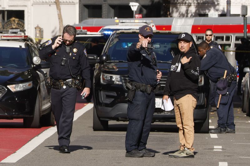 Police officers secure the area and investigate the scene of a shooting at Union Square in San Francisco on Saturday, Aug. 31, 2024. (Santiago Mejia/San Francisco Chronicle via AP)