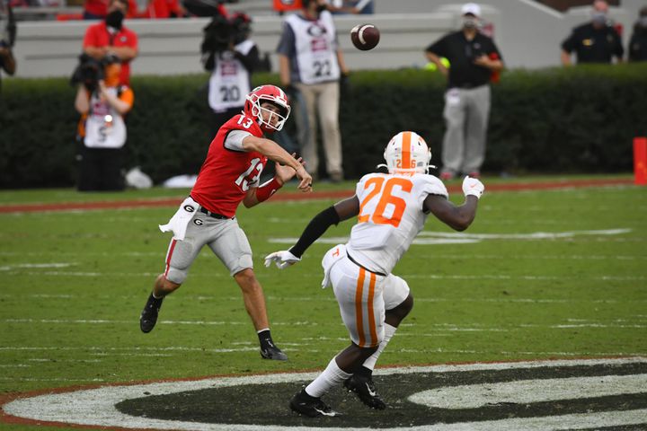 Georgia quarterback Stetson Bennett  passes over the defense of Tennessee defensive back Theo Jackson (26) during the second half of a football game Saturday, Oct. 10, 2020, at Sanford Stadium in Athens. Georgia won 44-21. JOHN AMIS FOR THE ATLANTA JOURNAL- CONSTITUTION