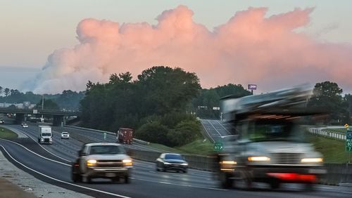 The large plume of smoke from a chemical plant fire on Sunday is still visible from I-20 eastbound near West Avenue in Conyers, Georgia, on Sept. 30, 2024. (John Spink/The Atlanta Journal-Constitution/TNS)