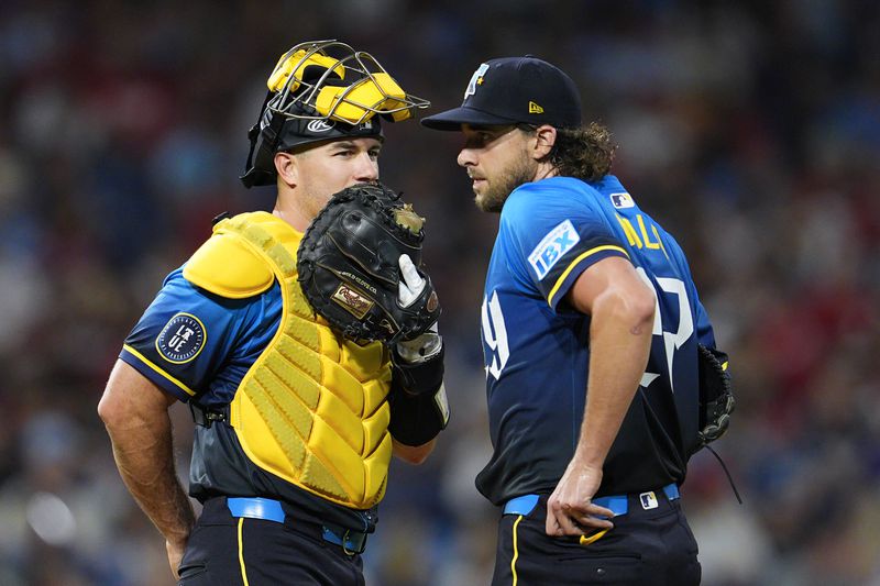 Philadelphia Phillies' Aaron Nola, right, talks to J.T. Realmuto during the fifth inning of a baseball game against the New York Mets, Friday, Sept. 13, 2024, in Philadelphia. (AP Photo/Derik Hamilton)