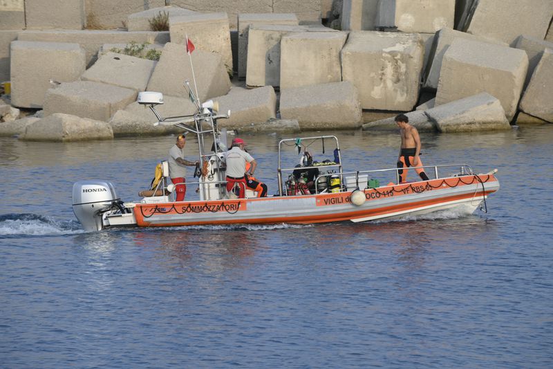 Italian Firefighters scubadivers sails towards the area where the UK flag vessel Bayesan that was hit by a violent sudden storm, sunk early Monday, Aug. 19, 2024, while at anchor off the Sicilian village of Porticello near Palermo, in southern Italy. (AP Photo/Lucio Ganci)