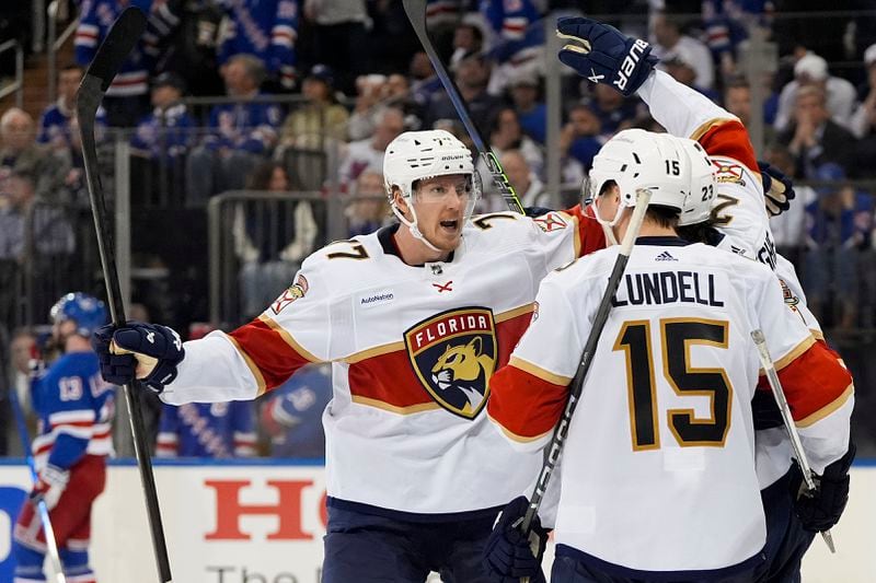 Florida Panthers defenseman Niko Mikkola (77) celebrates with teammates after a goal by Florida Panthers center Carter Verhaeghe (not pictured) against the New York Rangers during the third period of Game 1 of the NHL hockey Eastern Conference Stanley Cup playoff finals, Wednesday, May 22, 2024, in New York. (AP Photo/Julia Nikhinson)