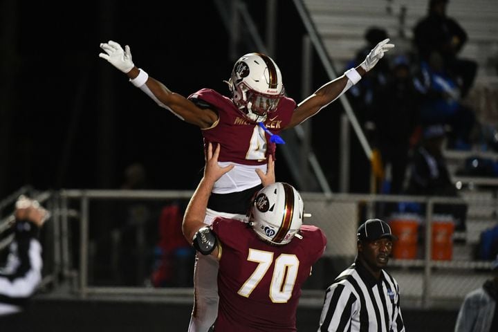 Makhail Wood, wide receiver for Mill Creek, celebrates a touchdown. (Jamie Spaar for the Atlanta Journal Constitution)