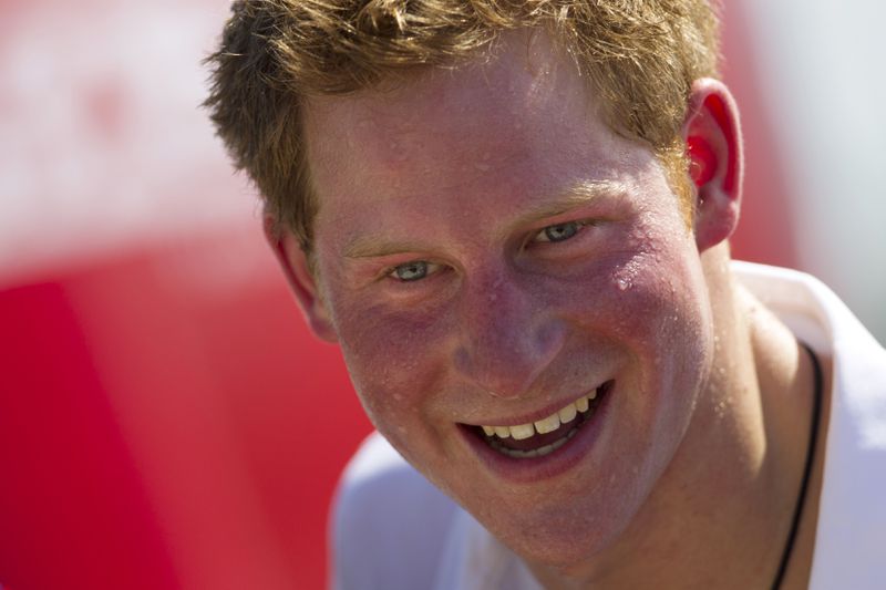 FILE - Britain's Prince Harry, smiles after playing rugby at Flamengo's beach in Rio de Janeiro, Brazil, Saturday March 10, 2012. (AP Photo/Felipe Dana, File)