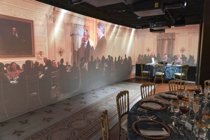 A 3D interactive room with dinner tables, music and videos of State Dinners at the White House, shown at The People's House exhibit, Monday, Sept. 16, 2024 in Washington. (AP Photo/Jose Luis Magana)