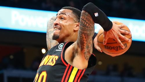 Hawks forward John Collins soars to the basket for a slam agains the Indiana Pacers during the first period in a NBA basketball game on Tuesday, Feb. 8, 2022, in Atlanta.  “Curtis Compton / Curtis.Compton@ajc.com”`
