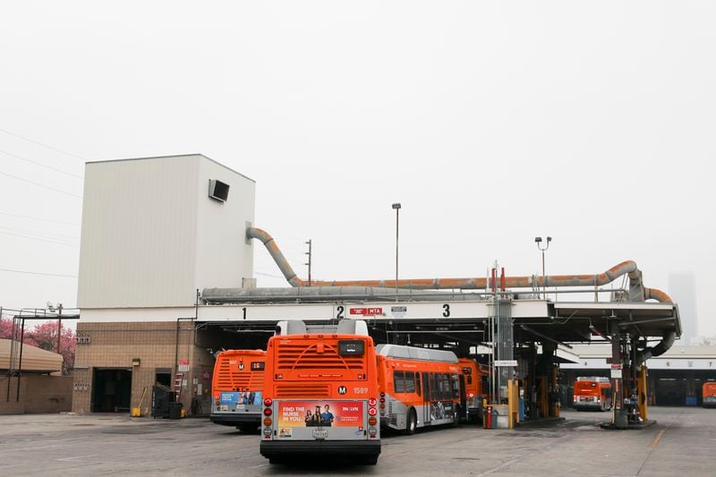 Buses enter a Los Angeles MTA bus depot near the site where overnight a bus was hijacked by an armed subject with passengers on board Wednesday, Sept. 25, 2024, in Los Angeles. One person was fatally shot before police apprehended the suspect. (AP Photo/Ryan Sun)