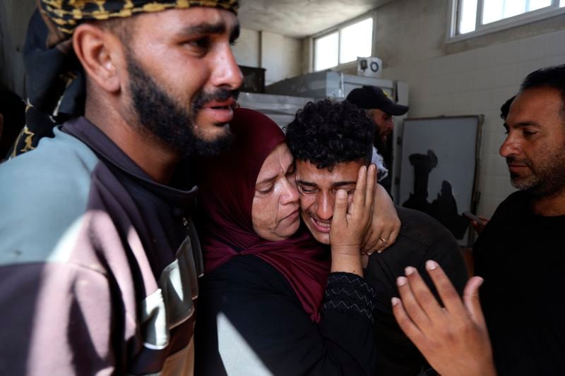 Palestinians mourn their relative Tamer Mohsen killed in the Israeli bombardment of Nuseirat refugee camp, at the morgue of al-Aqsa Martyrs hospital in Deir al Balah, central Gaza Strip, Wednesday, June 19, 2024. (AP Photo/Saher Alghorra)