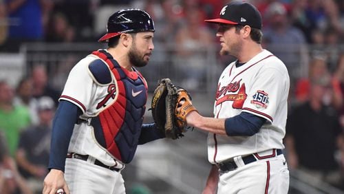 September 28, 2021 Atlanta - Atlanta Braves catcher Travis d'Arnaud (16) and Atlanta Braves relief pitcher Luke Jackson (77) celebrate at the end of the 8th inning at Truist Park on Tuesday, September 28, 2021. Atlanta Braves won 2-1 over Philadelphia Phillies. (Hyosub Shin / Hyosub.Shin@ajc.com)