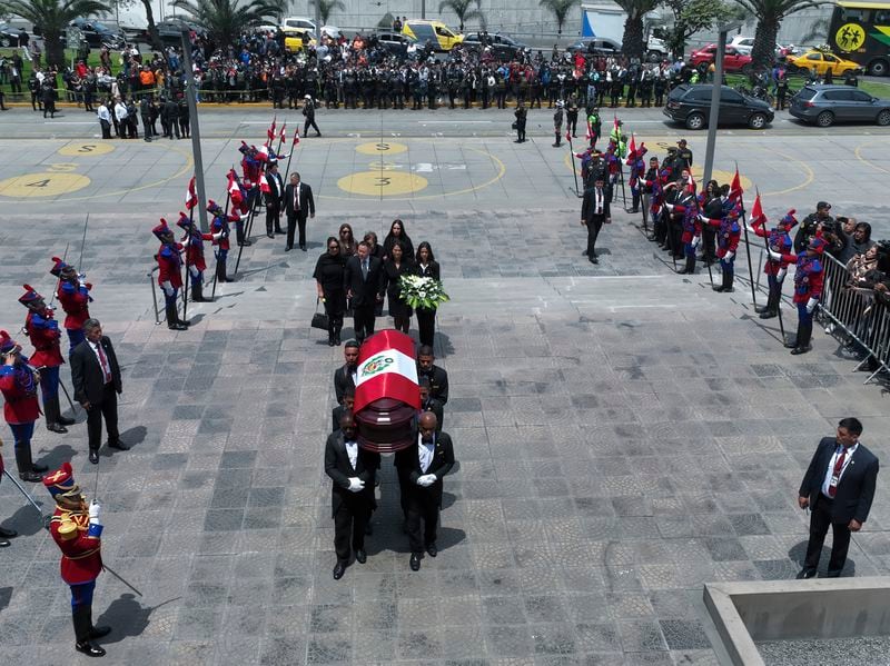 Keiko Fujimori, her brother Kenji, and other relatives follow pallbearers carrying the coffin of their father, former President Alberto Fujimori, to a museum for his wake in Lima, Peru, Thursday, Sept. 12, 2024. (AP Photo/Guadalupe Pardo)