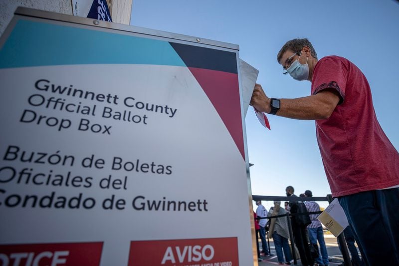 A voter places his absentee ballot inside a drop box during early voting in the 2020 election. Mark Andrews, a metro Atlanta man who was falsely accused of election fraud in the film "2000 Mules" after he legally deposited several absentee ballots for family members, received an apology from the film's publisher, Salem Media Group. The apology was apparently part of a settlement of his defamation case against Salem and the film's producers. (Alyssa Pointer/Atlanta Journal-Constitution/TNS)
