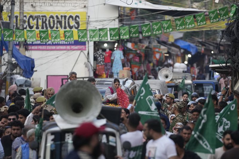 FILE- Mehbooba Mufti, leader of the Peoples Democratic Party (PDP), greets supporters during a campaign rally of Jammu and Kashmir Assembly elections in Jammu, India, Sept. 25, 2024. (AP Photo/Channi Anand, File)