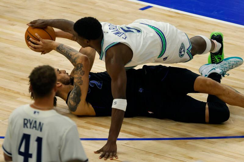 Dallas Mavericks center Dereck Lively II (2) and Minnesota Timberwolves guard Anthony Edwards (5) scramble for the ball during the second half of Game 2 of the NBA basketball Western Conference finals, Friday, May 24, 2024, in Minneapolis. (AP Photo/Bruce Kluckhohn)