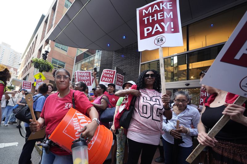 Union members from Local 26, representing workers in the hospitality industries of Massachusetts, picket outside the Hyatt Regency Boston, Wednesday, July 17, 2024, in Boston. (AP Photo/Charles Krupa)