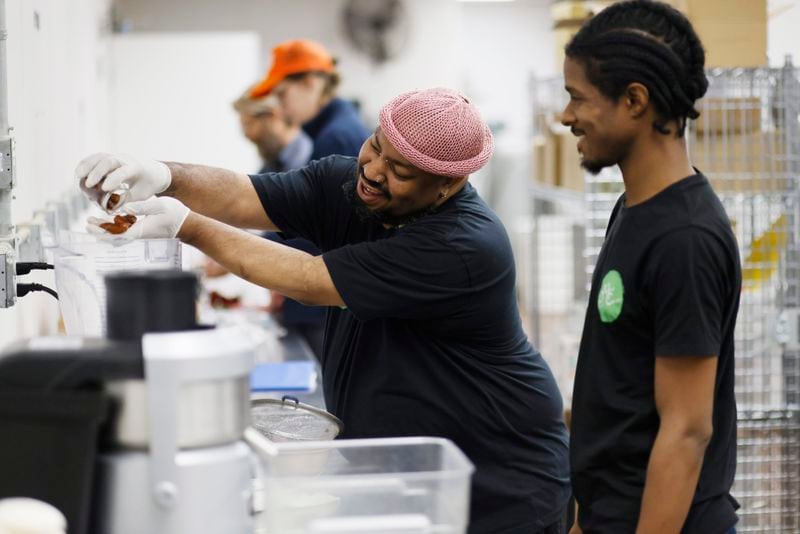 Antonio Little (left) adds dates to his pecan milk while his co-worker Nil Jones looks on. They are part of a company co-owned by six employees called Pekan Milk Cooperative, which produces various milk, including pecan, oat, hemp, and sunflower milk. Thursday, April 13, 2023.
Miguel Martinez /miguel.martinezjimenez@ajc.com