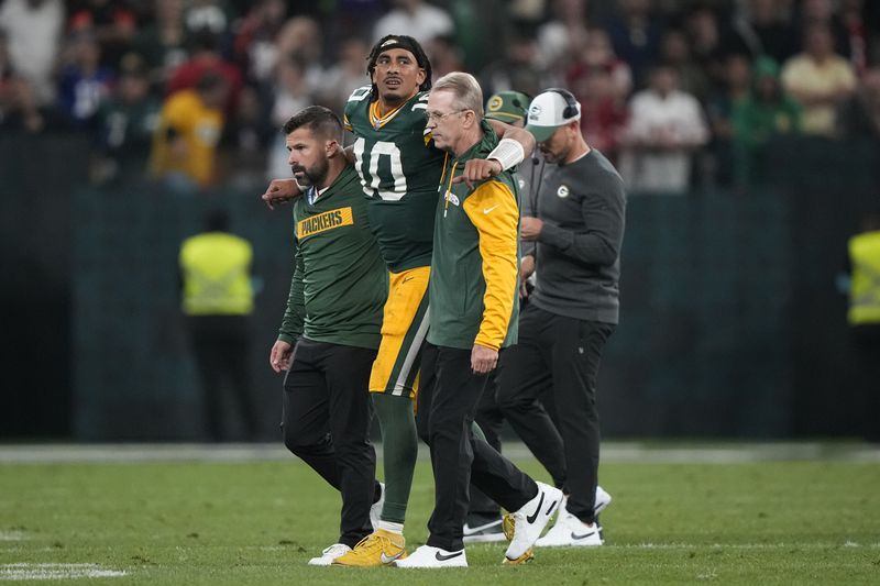 Green Bay Packers quarterback Jordan Love (10) is helped off the field after getting hurt during the second half of an NFL football game against the Philadelphia Eagles, Saturday, Sept. 7, 2024, at the Neo Quimica Arena in Sao Paulo. (AP Photo/Doug Benc)