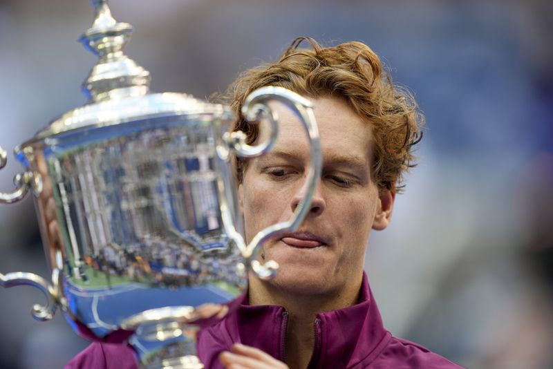 Jannik Sinner, of Italy, holds up the championship trophy after defeating Taylor Fritz, of the United States, in the men's singles final of the U.S. Open tennis championships, Sunday, Sept. 8, 2024, in New York. (AP Photo/Julia Nikhinson)